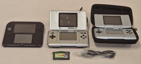 Two Nintendo DS handheld consoles together with a Nintendo 2DS, power lead and a game cartridge.