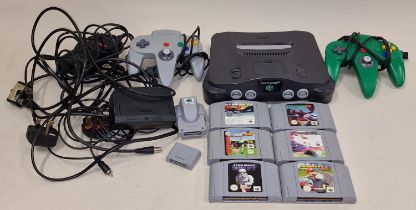 Nintendo 64 game console together with two controllers, power leads and six game cartridges.