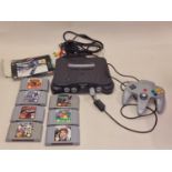 Nintendo 64 console with controller, leads and eight game cartridges.