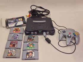 Nintendo 64 console with controller, leads and eight game cartridges.