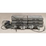Collection of six Sony PlayStation consoles together with three controllers and associated leads.