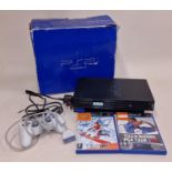 Boxed Sony PlayStation 2 with controller, power lead and two games. This lot has not been tested.