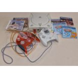 Sega Dreamcast console together with two controllers and four games. This lot has not been tested.