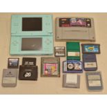 Nintendo DS Lite console together with a collection of game cartridges and memory cards.