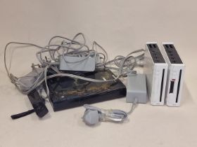 Two Nintendo Wii consoles together with a Wii U console, associated controllers and leads. This