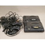 Two Sega Mega Drive consoles together with associated controllers and leads. This lot has not been