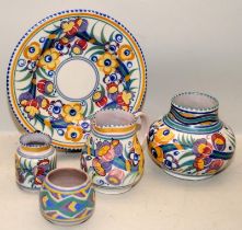 A collection of early red bodied Poole Pottery in the traditional pattern. Five pieces in lot.
