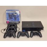 Sony PlayStation 2 console together with five various controllers and a boxed Laser Blaster.