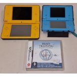 Nintendo DSi XL console together with a Nintendo DSi console and a Nintendo DS Brain Training