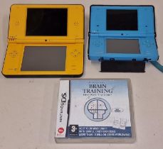 Nintendo DSi XL console together with a Nintendo DSi console and a Nintendo DS Brain Training