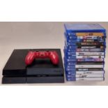 Sony PlayStation 4 console together with a controller and a collection of games.