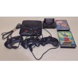 Sega Mega Drive II together with three controllers, leads and some games.