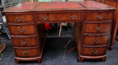 Twin pedestal desk with tooled leather inset top above nine drawers 76x122x60cm.