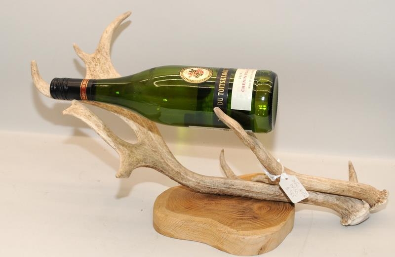 Mounted antler on wooden plinth fashioned as a bottle holder