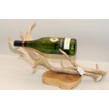 Mounted antler on wooden plinth fashioned as a bottle holder
