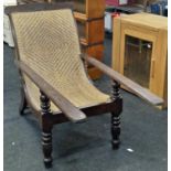 Anglo Dutch colonial Plantation chair with arm extenders on turned supports with a woven back rest