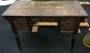 Stained pine 5 draw writing table on turned supports with brass drop handles 70x110x50cm