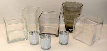 A collection of contemporary glass items to include a pitcher, square planters and tealight holders.