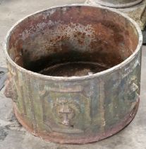 An antique cast iron garden planter decorated with lion heads 30cm tall with a diameter of 53cm.