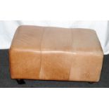 Large and faded Ottoman in tan leather. 90cms x 40cms x 62cms