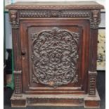 Heavily ornately carved poss "Green Man" single door cupboard with internal fitted shelve and key