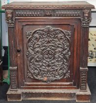 Heavily ornately carved poss "Green Man" single door cupboard with internal fitted shelve and key