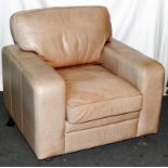 Large and faded gentleman's tan leather deep armchair. Seat height 42cms, width across back 100cms