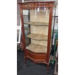 Edwardian mahogany single door glass front display case having curved front feature standing on