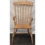 Vintage Elm Windsor arm chair with slate backs and standing on turned supports with a H cross