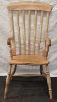 Vintage Elm Windsor arm chair with slate backs and standing on turned supports with a H cross