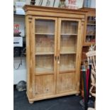 Antique pine 2 door glassed bookshelf/cupboard set on stub feet with key 190x120x35cm