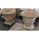 Pair of vintage reconstituted concrete garden urns on bases each 57cm high and 61cm diameter at