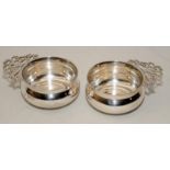 A pair of sterling silver porringers or wine tasters. Hallmarked for London 1912. 7cms across, 81g