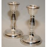 Pair of Sterling silver candlesticks 11cms tall with weighted bases. Hallmarked for Birmingham 1961.