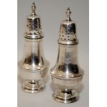 Pair of antique sterling silver pepperettes hallmarked for Birmingham 1915. 9.5cms tall, 77g