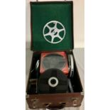 Case containing a collection of home movie film reels, spare film spools and film splicer