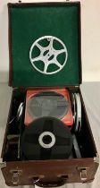 Case containing a collection of home movie film reels, spare film spools and film splicer