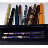 A collection of fountain and ballpoint pens