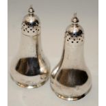 A pair of antique sterling silver pepperettes hallmarked for London 1916. 8cms tall, 49g