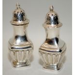 A pair of Victorian sterling silver pepperettes hallmarked for Sheffield 1895. 8.5cms tall, 44g