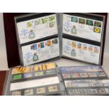 Large album of GB mint stamps presentation packs together with a large album of GB First Day