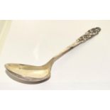 A NORWEGIAN 'MYLIUS BRODRENE' SILVER SERVING SPOON. WITH STYLISED SCROLLING FOLIATE HANDLE. 23CM