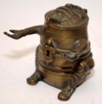 Novelty vintage brass pen holder and inkwell in grotesque form. 9cms tall