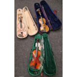 Three modern violins all in cases.