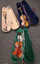Three modern violins all in cases.