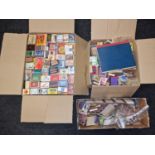 Three boxes containing a large collection of vintage match book covers and matchboxes.