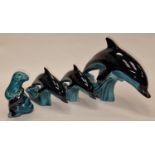 Poole Pottery collection of blue glazed animals to include three dolphins and a seal (4).