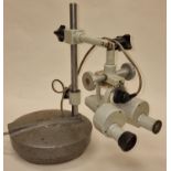 A vintage prior scientific microscope on heavy cast metal stand.