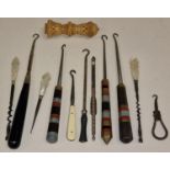 A collection of vintage crochet hooks together with a needle holder.