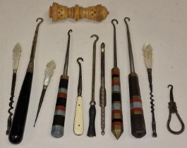 A collection of vintage crochet hooks together with a needle holder.